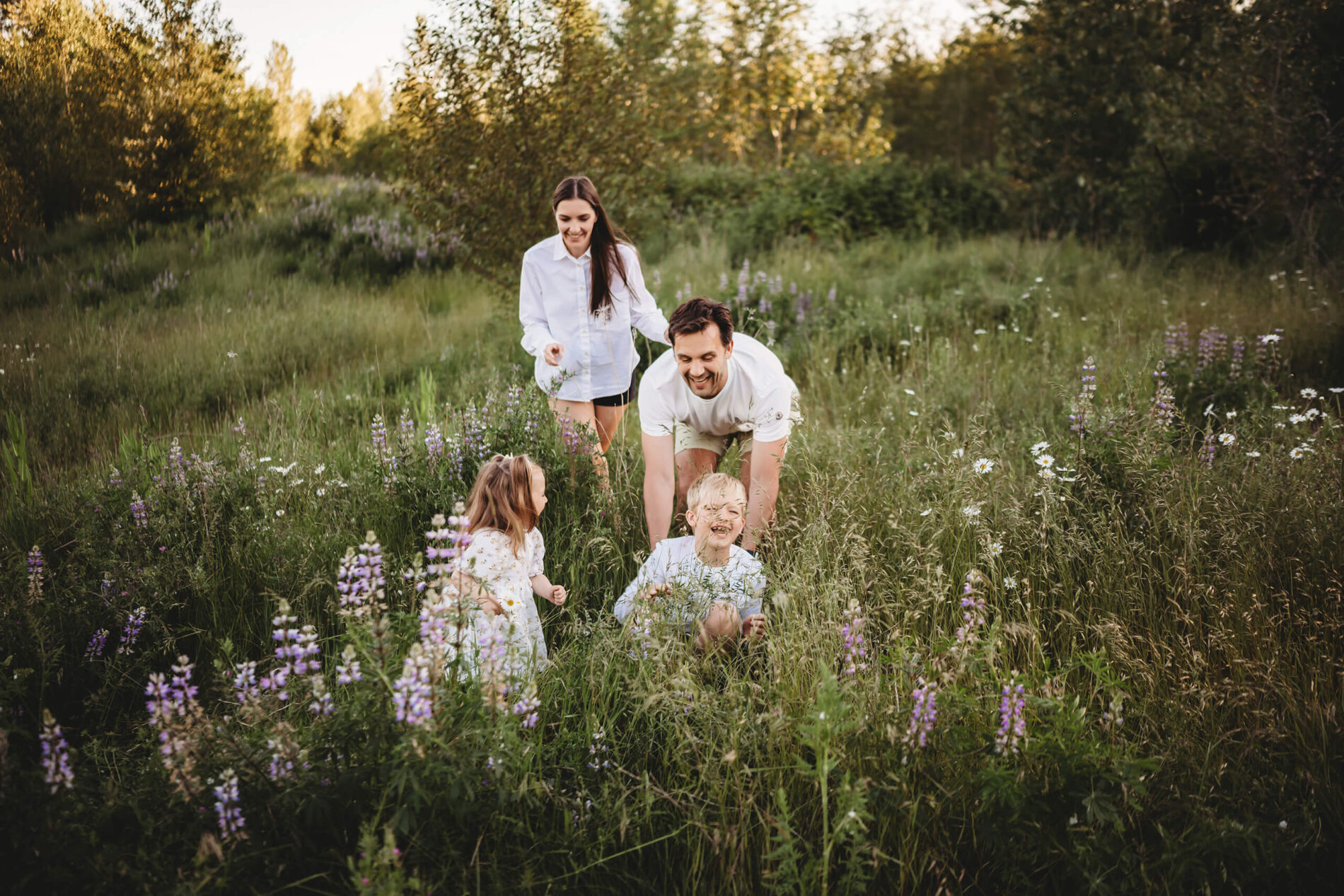 Family playing in a field of wildflowers during photoshoot in Seattle