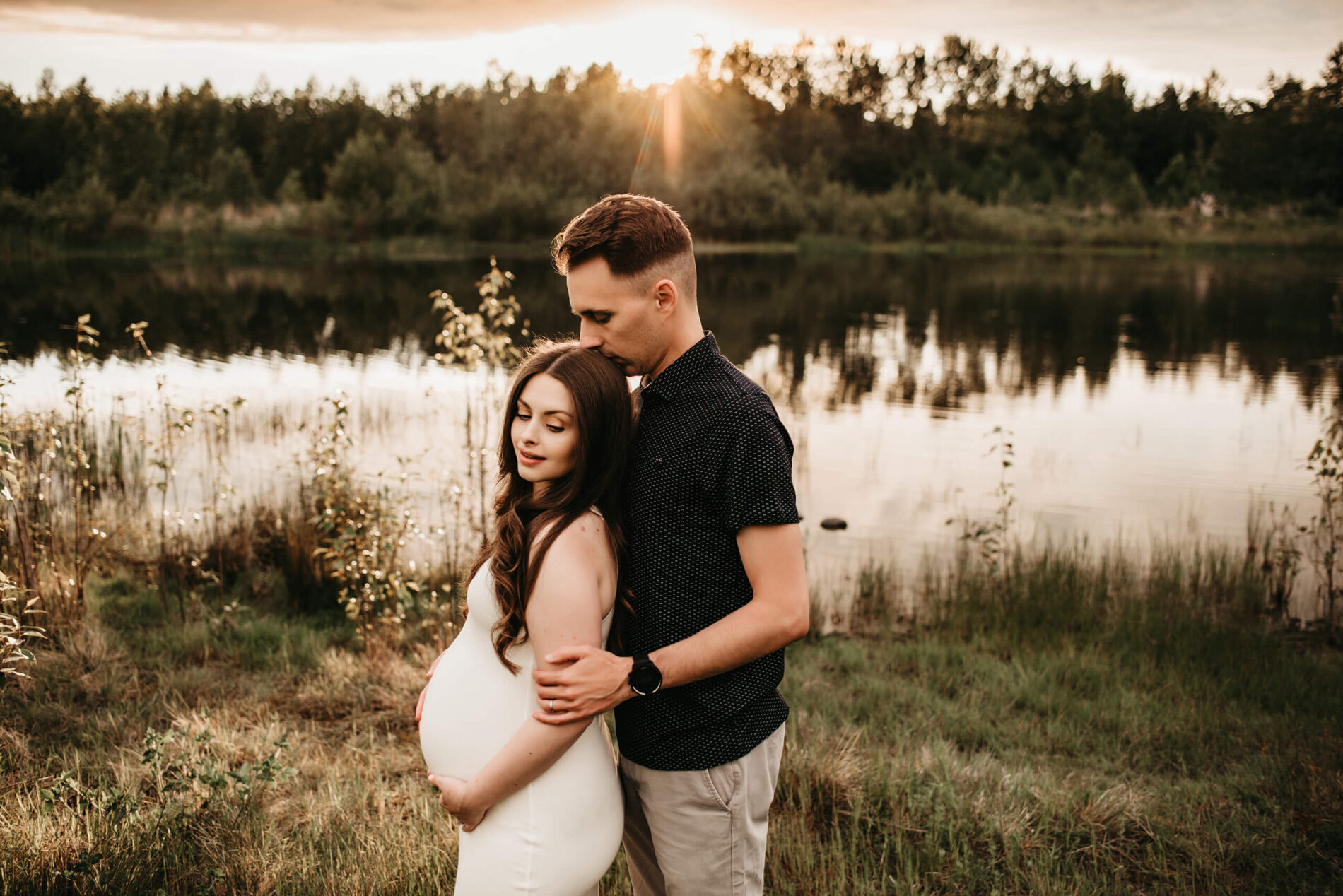 Seattle couple maternity session in an open wildflower field during sunset