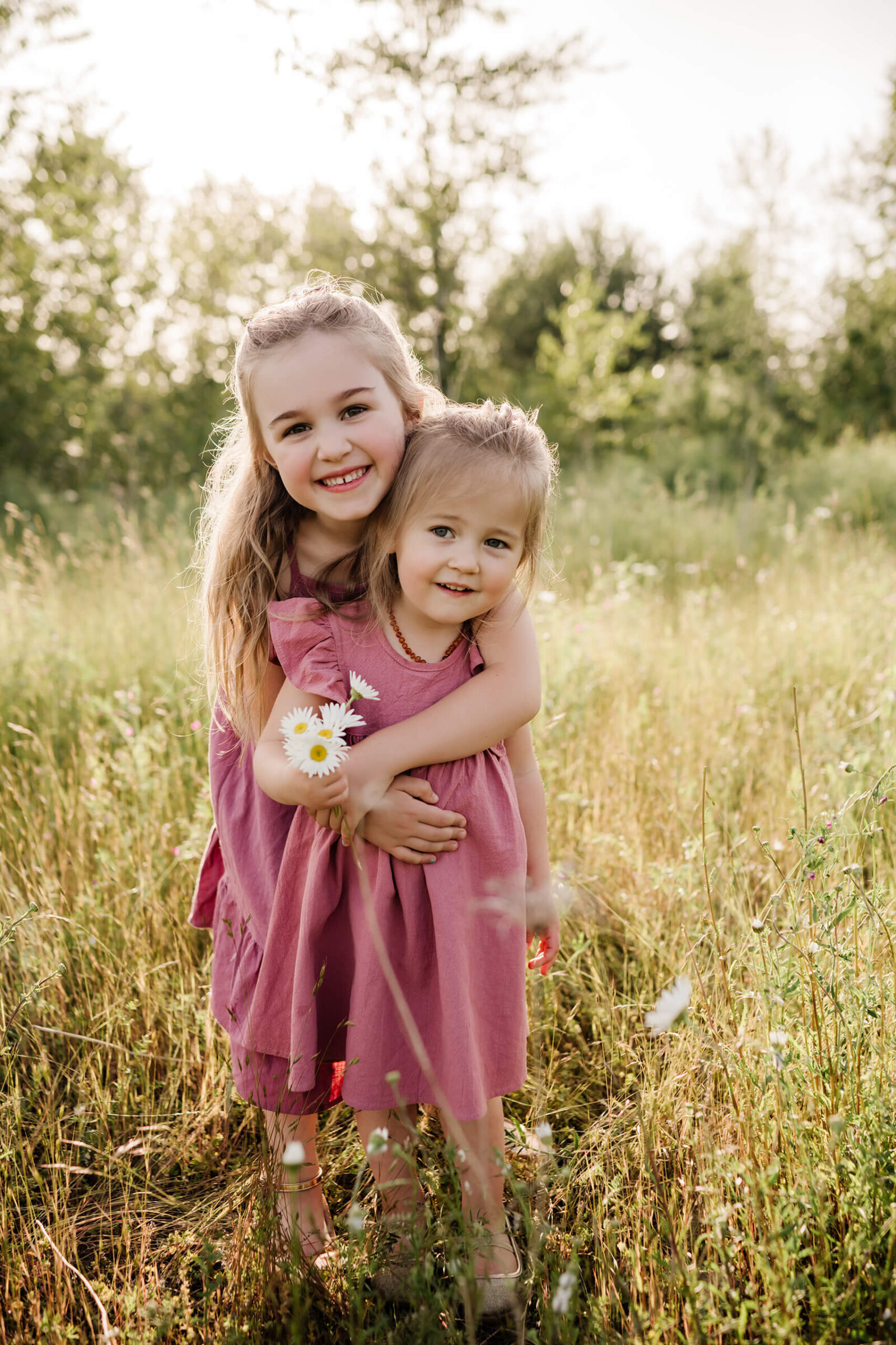 Portrait of siblings in a field of wildflowers