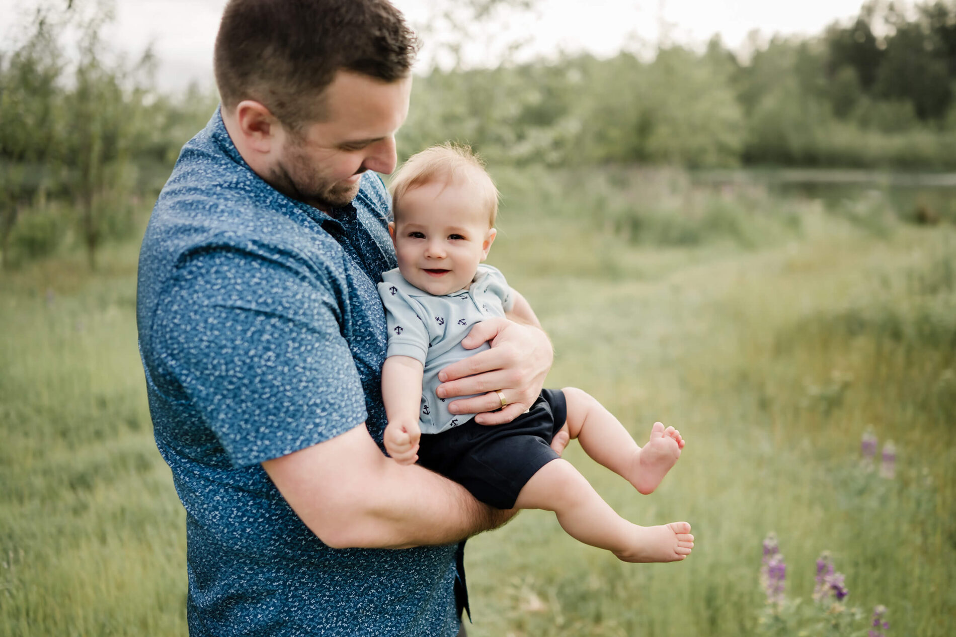 Dad holding his toddler son during lifestyle family photoshoot