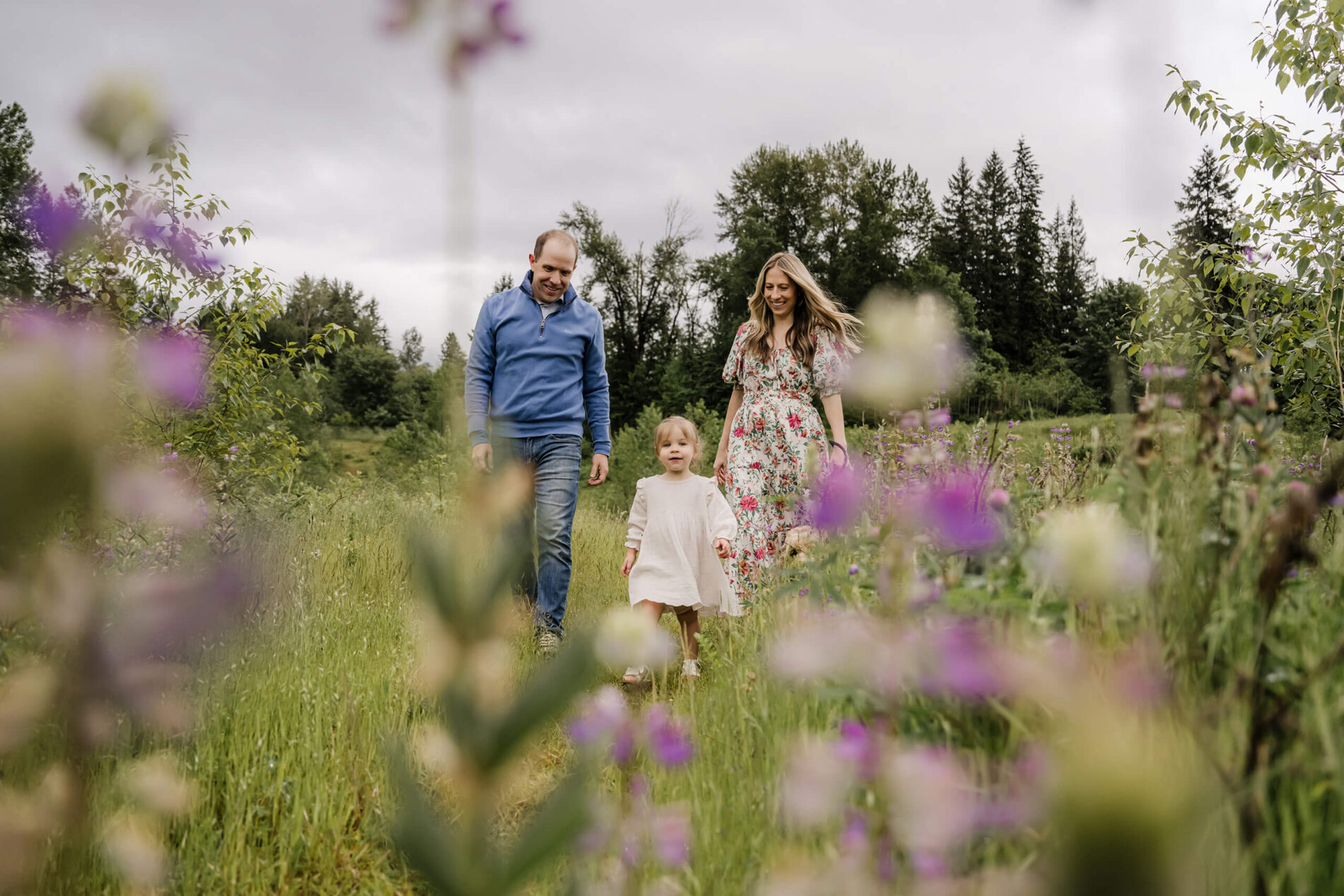 Family walking through a field of lupines during photoshoot