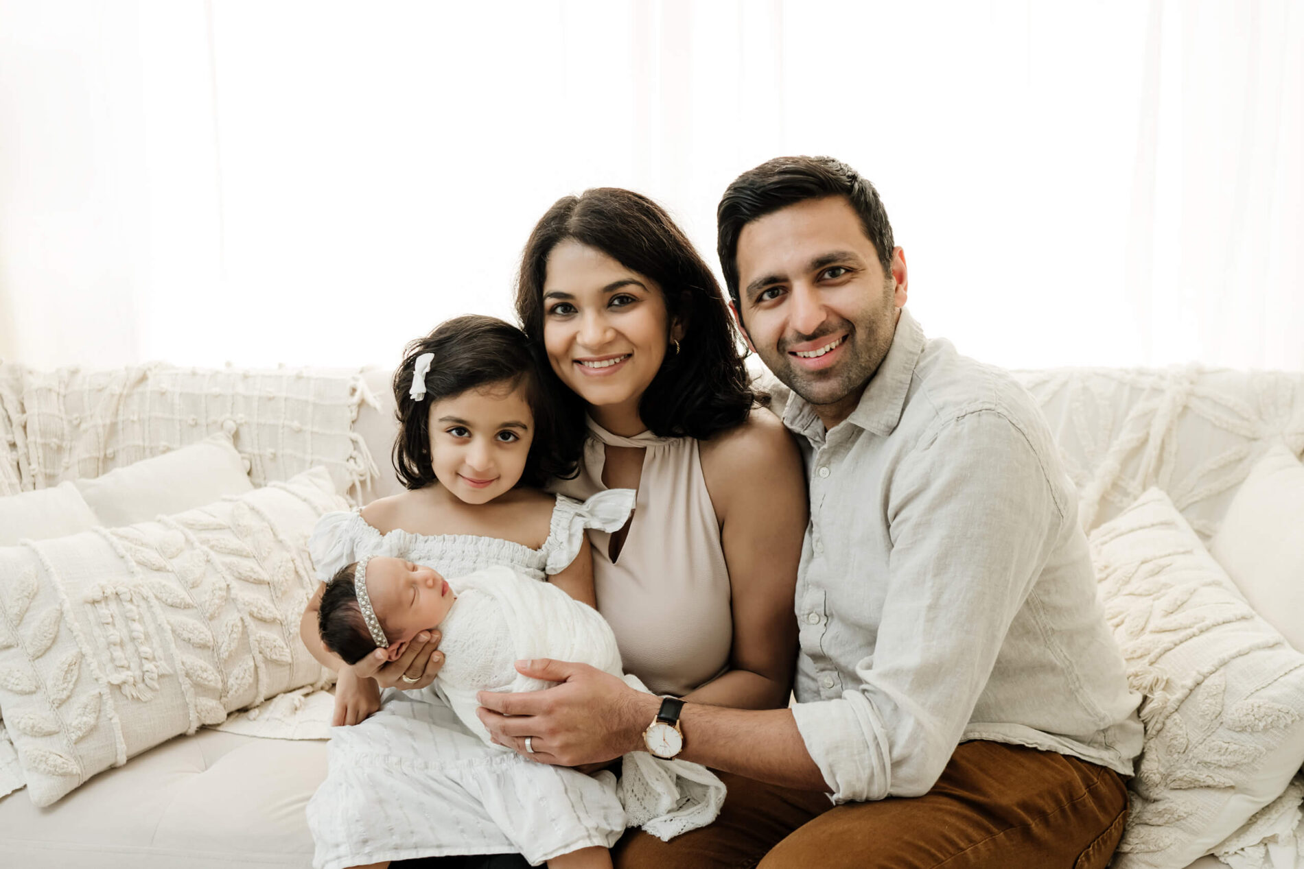 Maternity and newborn photographer in Kirkland WA posing a family in a studio