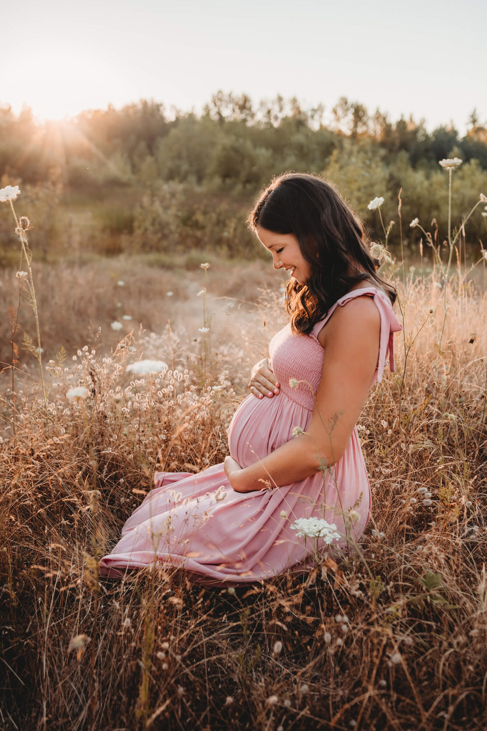 Maternity portrait during sunset in a field in Seattle area