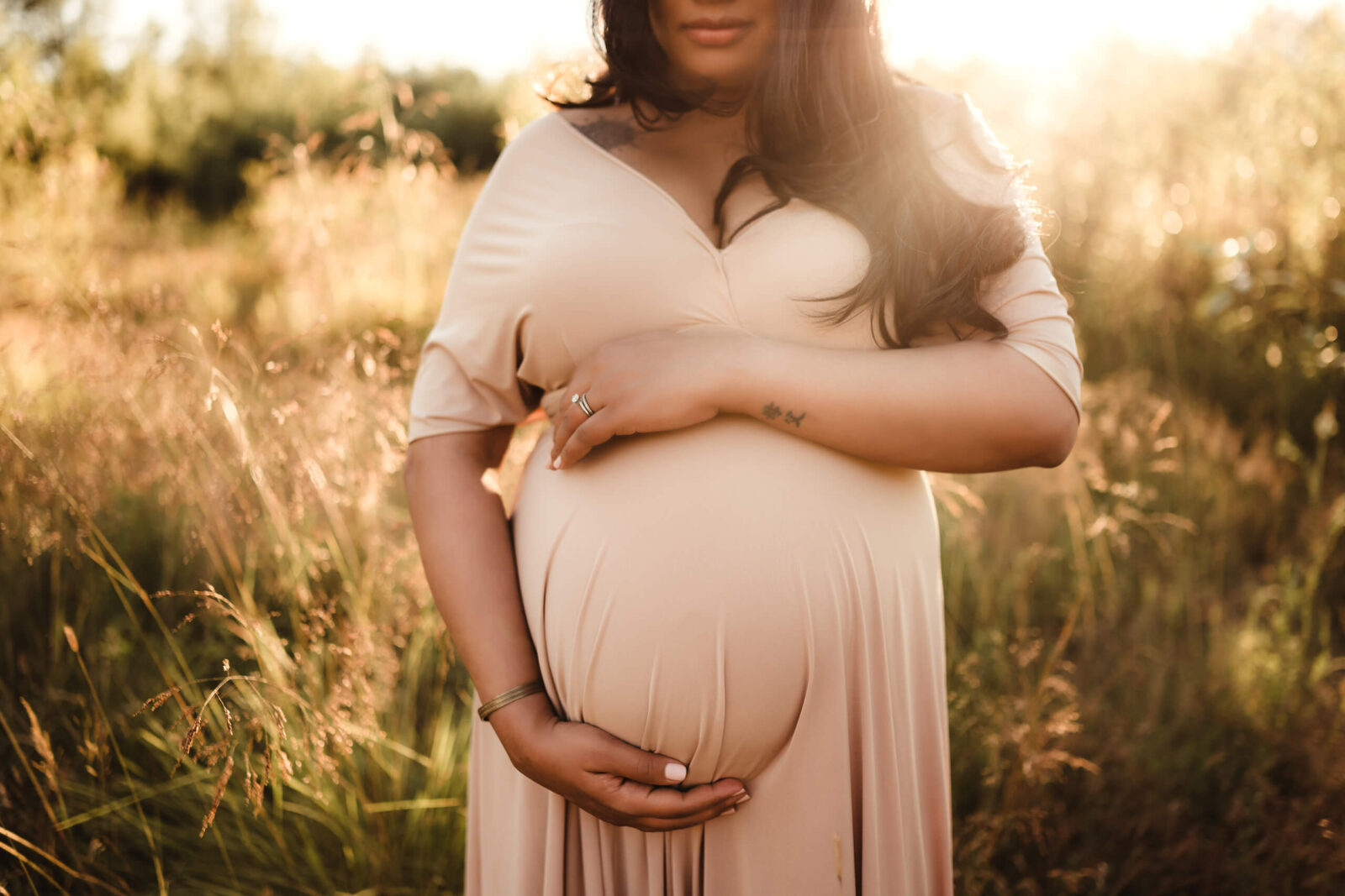 Seattle maternity photoshoot with a woman in a beautiful gown