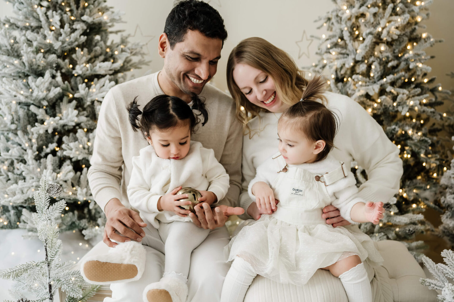 Seattle family studio holiday portraits with parents and two toddlers by decorated Christmas trees in Kirkland.