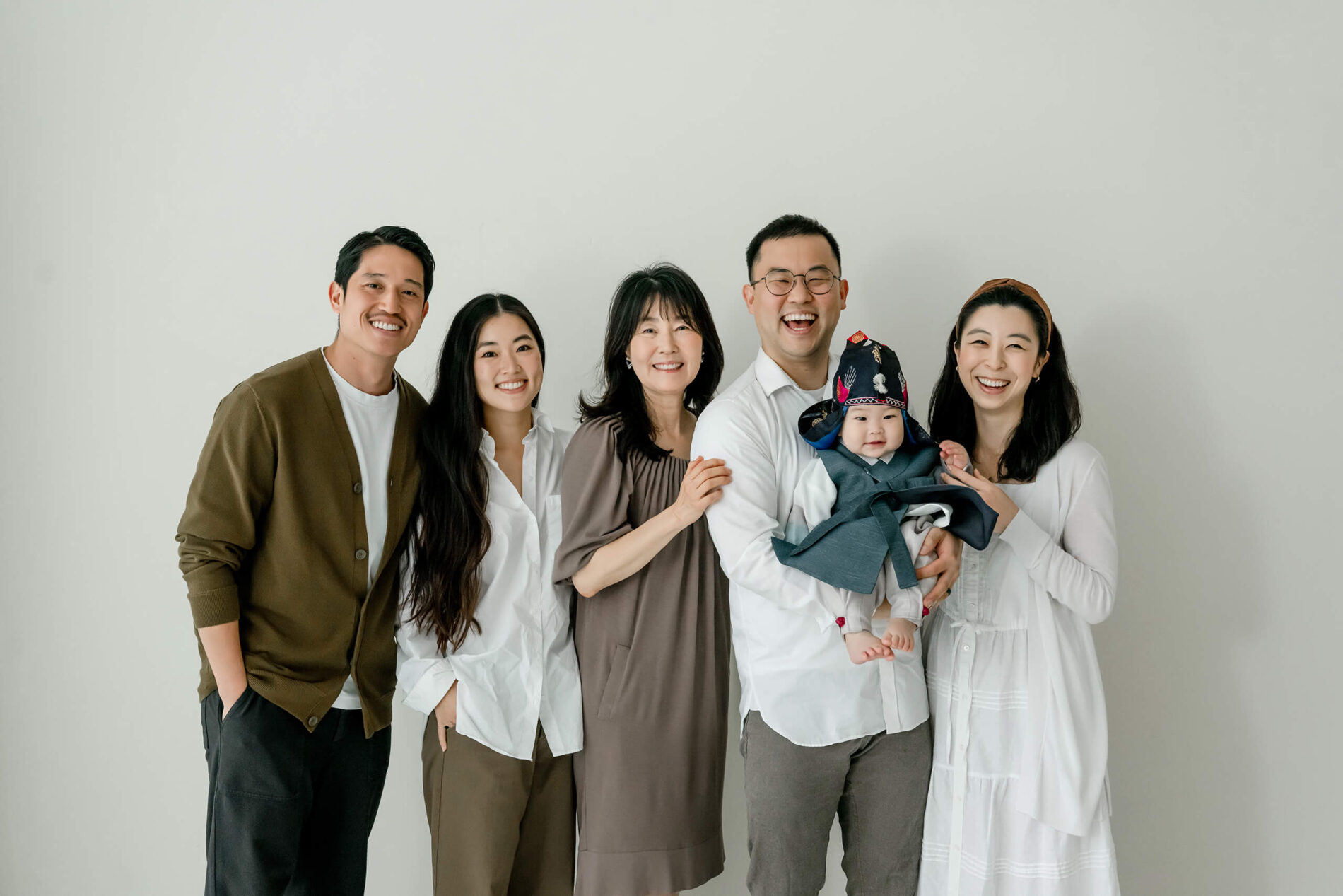 A multi-generational family standing together for a studio portrait in Kirkland.