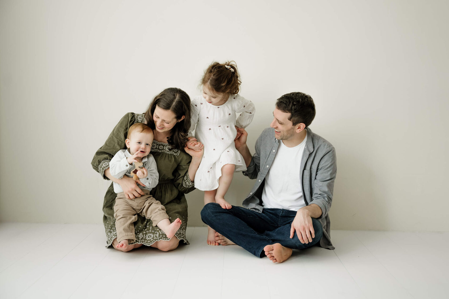 A family seated together with their children during a relaxed Seattle family studio session.