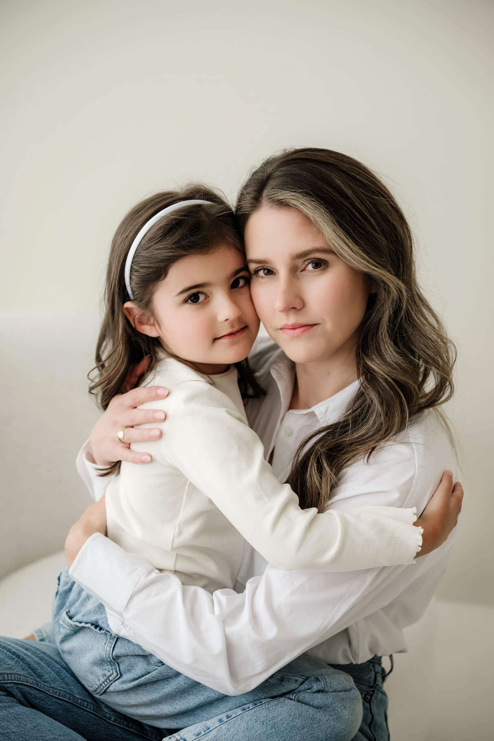 A natural portrait of a mother holding her daughter during a family studio session near Bellevue.