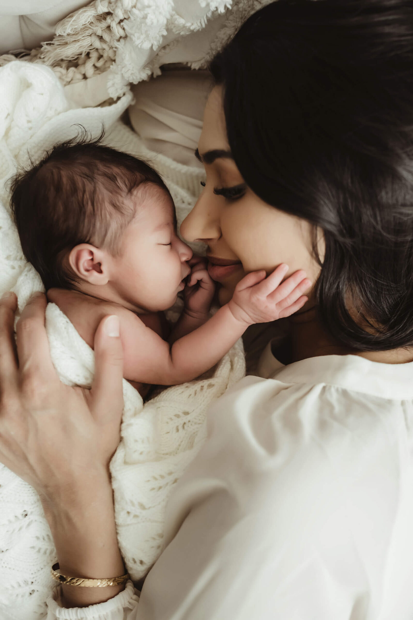 Mother cuddling nose-to-nose with her newborn baby during an intimate studio newborn session in Kirkland.