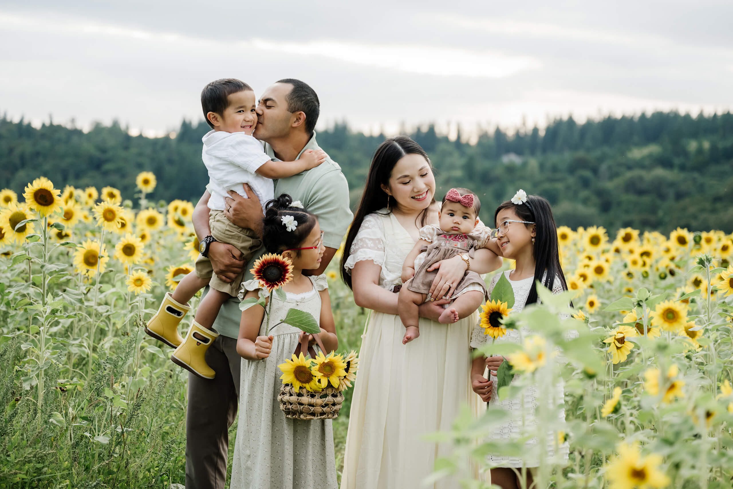 Family of six together in a sunflower field during a summer photo session in Duvall, Washington.